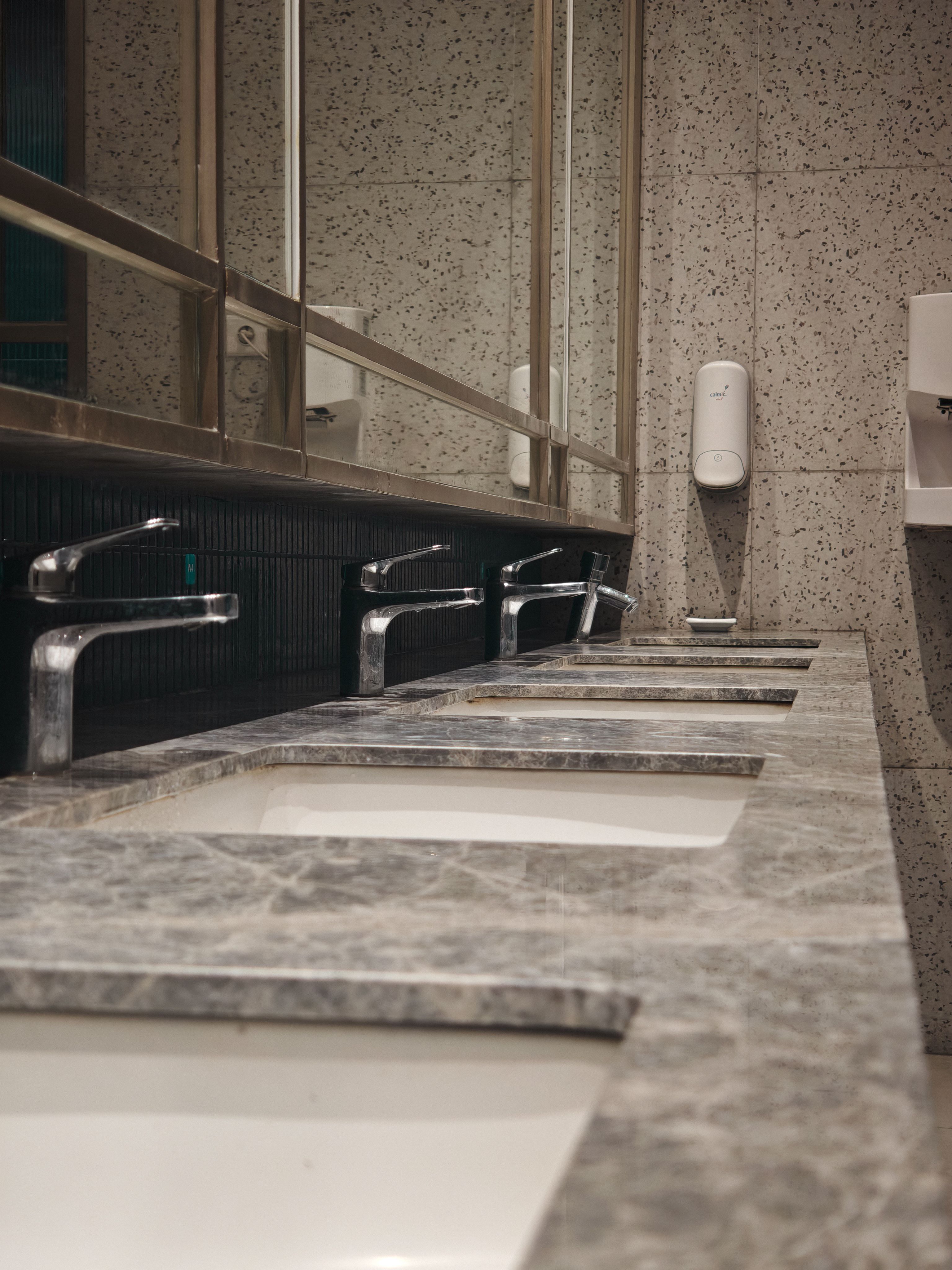 A restroom sink area in a commercial facility maintained by GR Collins Commercial Cleaning